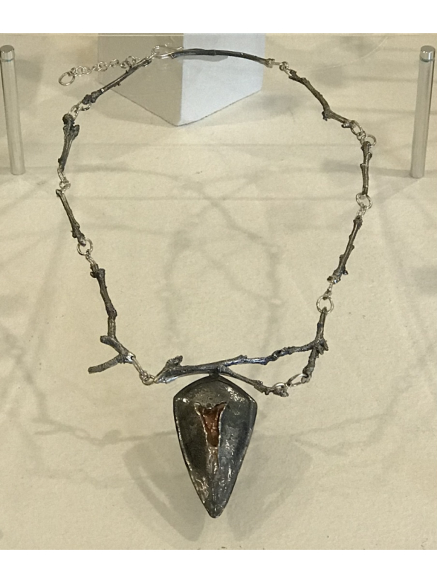 Silver necklace on display museum exhibition