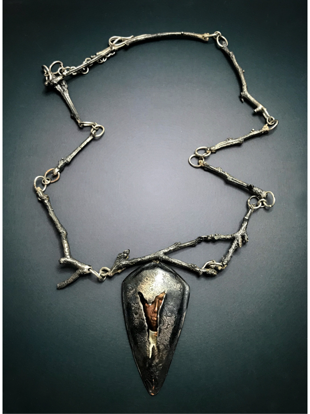 Contemporary art jewelry silver hidden face necklace