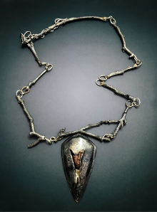 Contemporary art jewelry silver hidden face necklace